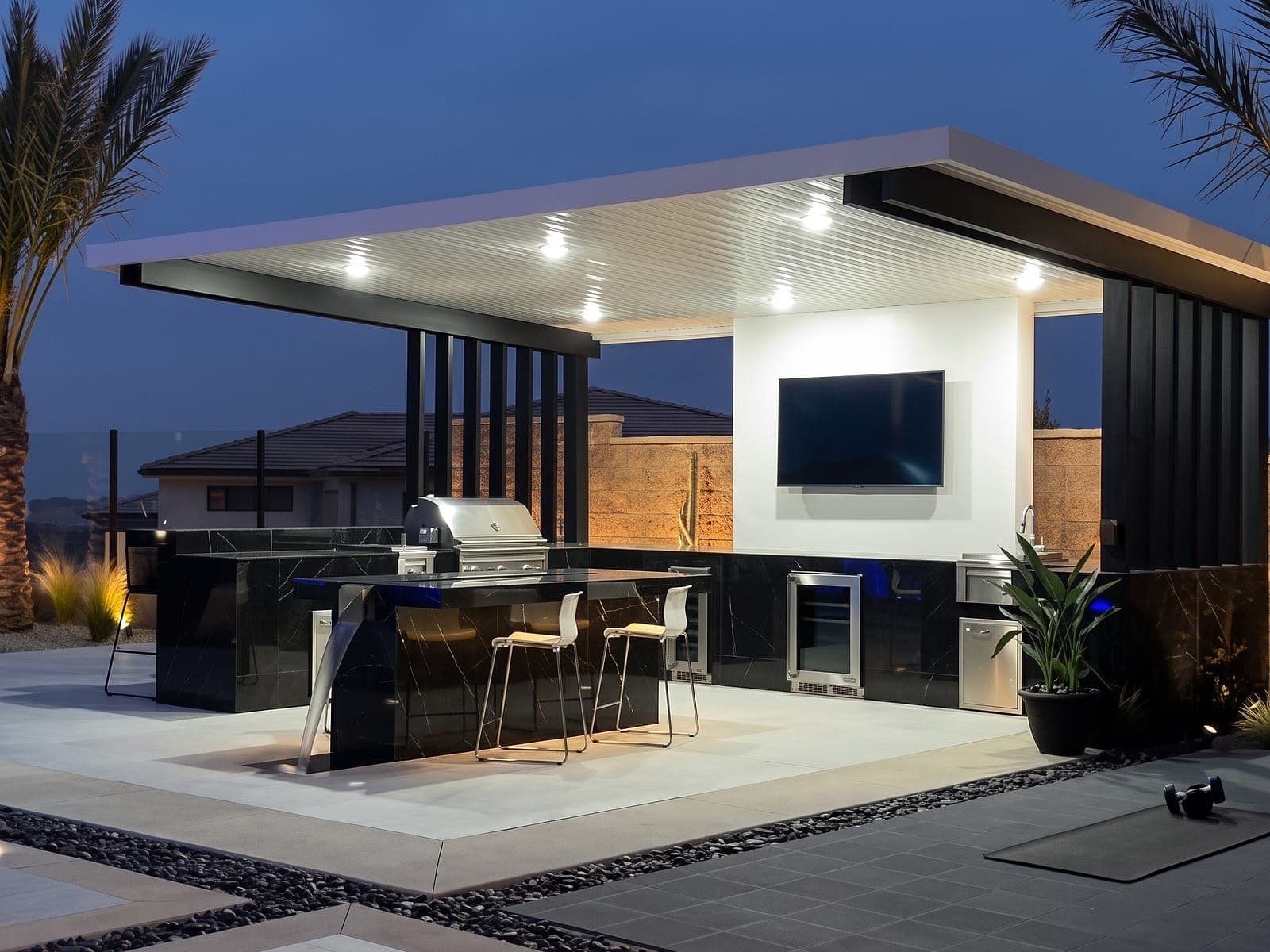 Cantilever with a white VEER Batten roof over an outdoor kitchen at dusk